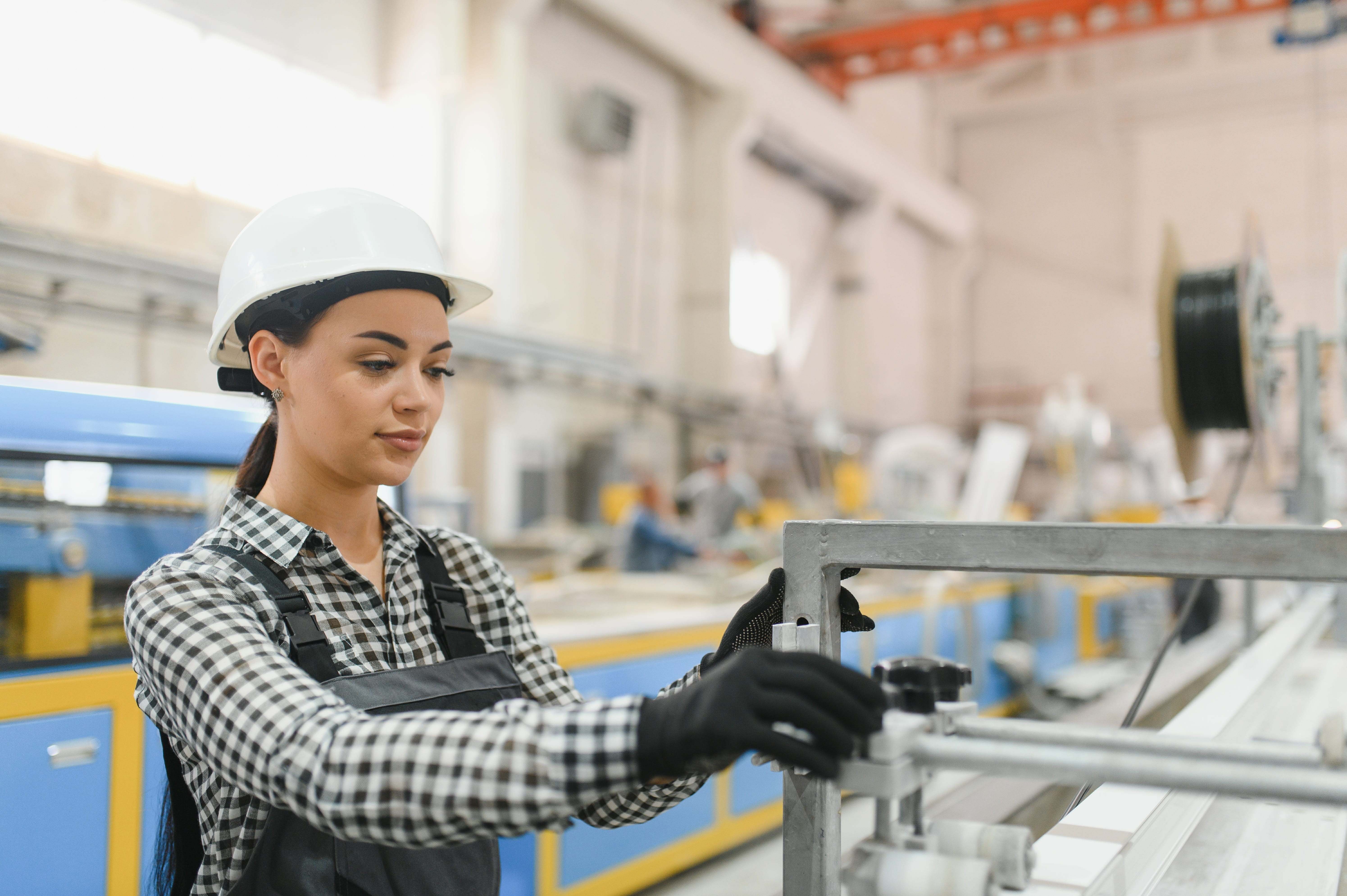 Factory worker assembling a manufactured component